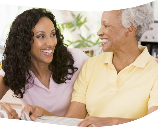 caregiver and patient looking to each other while smiling